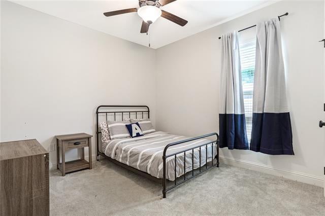 carpeted bedroom featuring ceiling fan