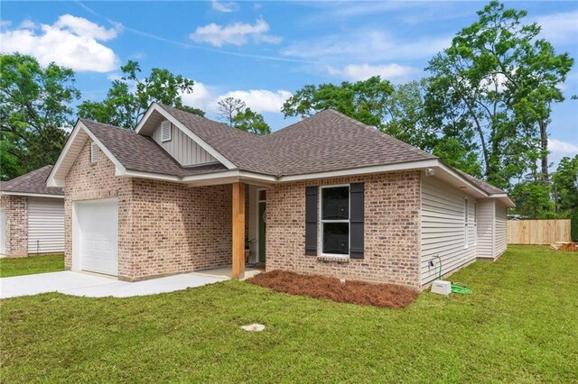 view of front of property with a garage and a front lawn