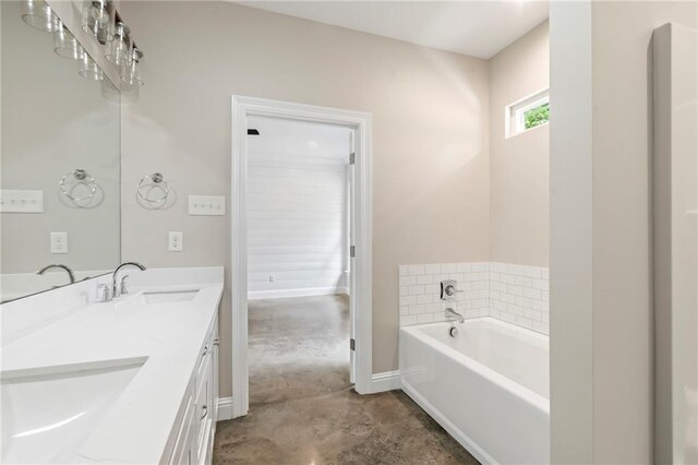 bathroom with concrete floors, a tub, and dual vanity