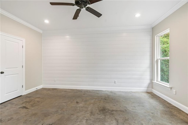 spare room with plenty of natural light, crown molding, ceiling fan, and concrete floors