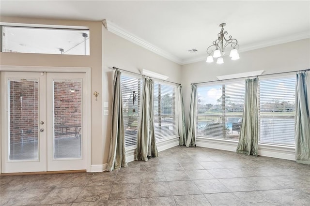 doorway to outside featuring a notable chandelier, crown molding, and french doors