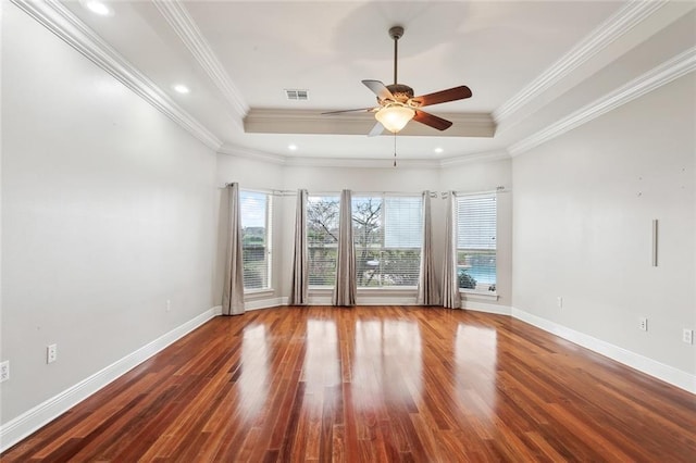 spare room with a tray ceiling, crown molding, and ceiling fan