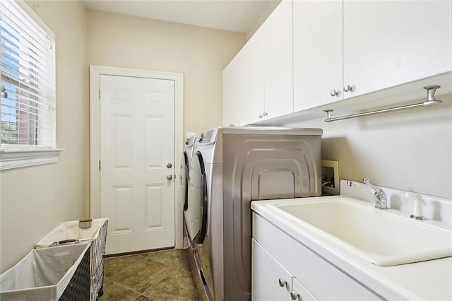 washroom featuring washer and clothes dryer, cabinets, and sink