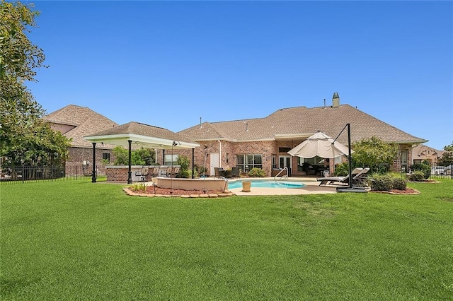 view of swimming pool featuring a patio, an outdoor bar, and a lawn