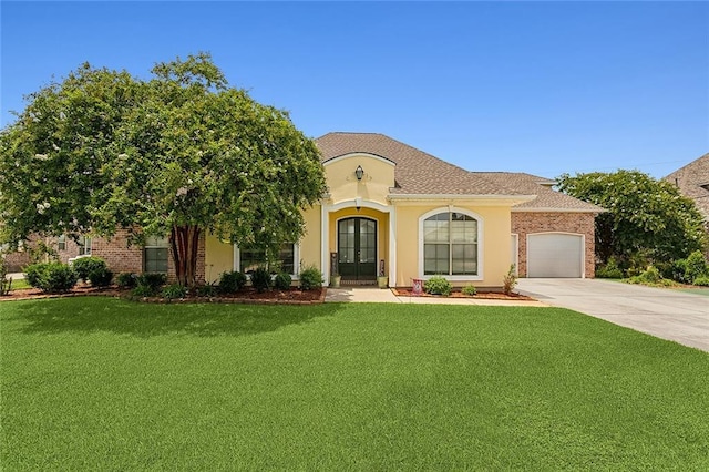 mediterranean / spanish-style house featuring a front yard, french doors, and a garage