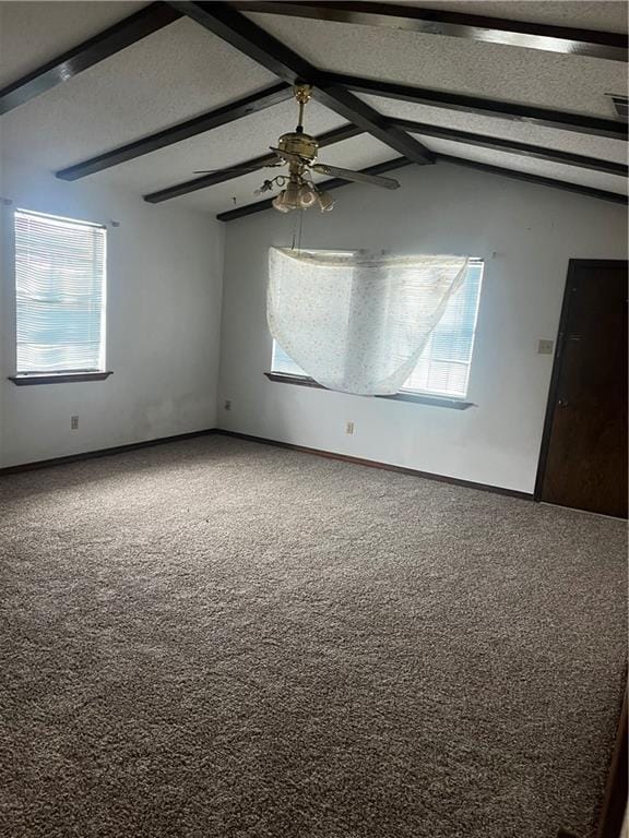 carpeted spare room with ceiling fan and lofted ceiling with beams