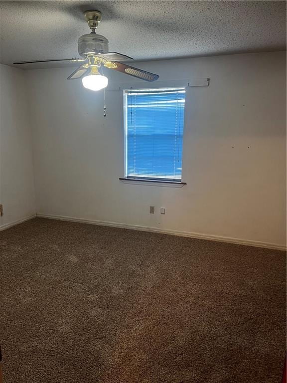 unfurnished room featuring ceiling fan, carpet flooring, and a textured ceiling