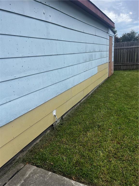 view of side of home with a lawn