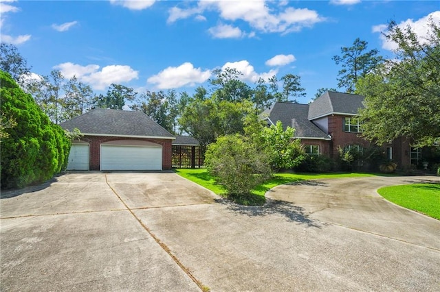 view of front of home with a garage and a front lawn