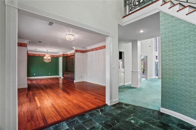30 River Cypress Ln, Madisonville, LA 70447 - empty room with a chandelier, baseboards, wallpapered walls, and an accent wall