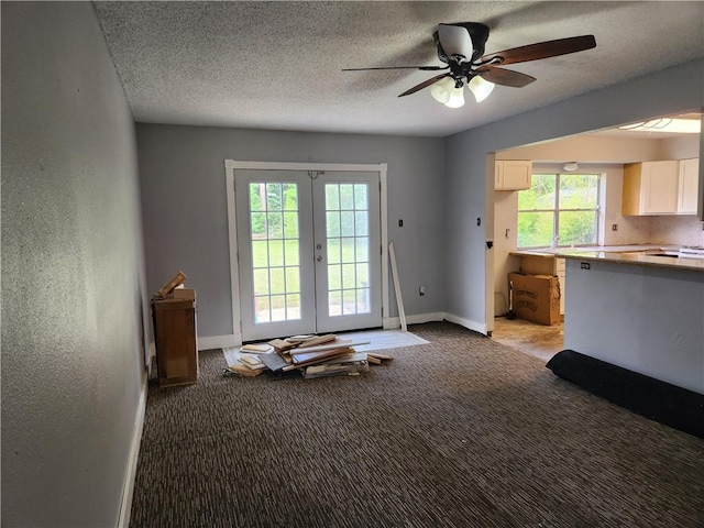 interior space with french doors, light carpet, a textured ceiling, and ceiling fan