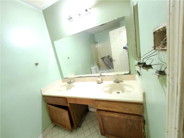 bathroom with vanity, toilet, and tile patterned flooring