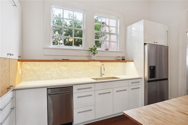 kitchen featuring white cabinetry, stainless steel fridge with ice dispenser, and sink