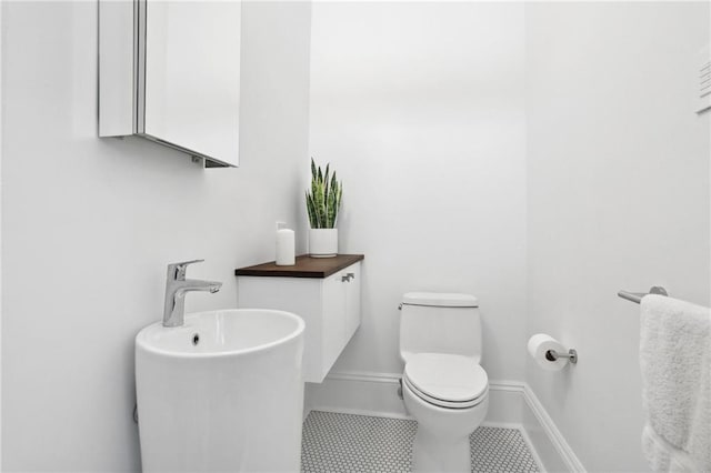 bathroom featuring tile patterned flooring and toilet