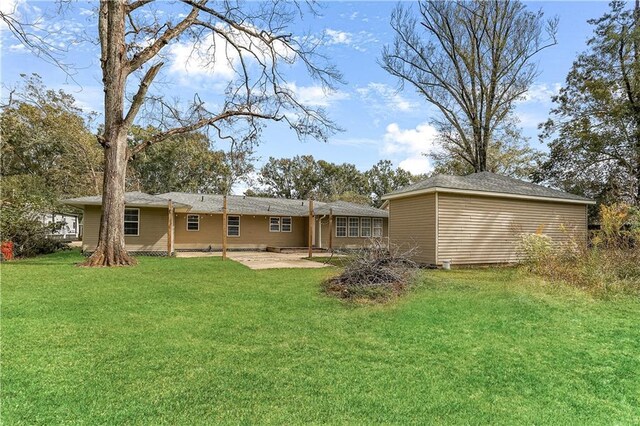 rear view of house with a yard and a patio area