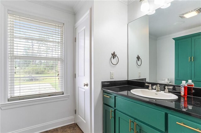 bathroom featuring vanity, crown molding, plenty of natural light, and tile patterned flooring