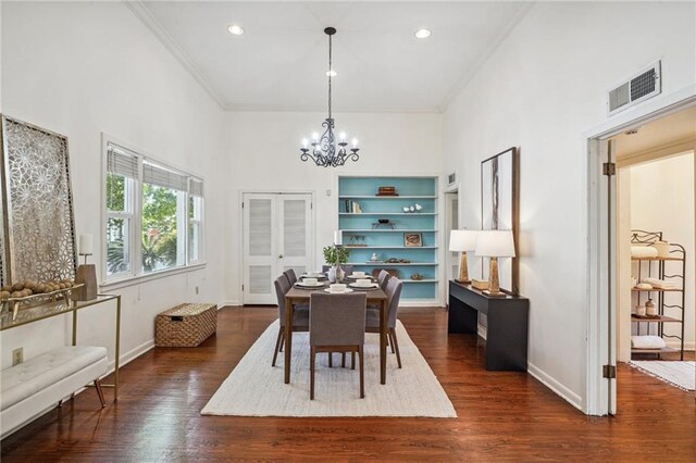 dining area featuring a chandelier, dark hardwood / wood-style floors, and ornamental molding