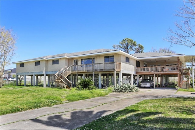 exterior space with a carport and a lawn