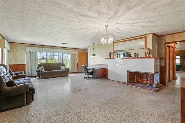 6461 Grand Caillou Rd, Houma, LA 70363 - living room featuring an inviting chandelier, ornamental molding, and wood walls
