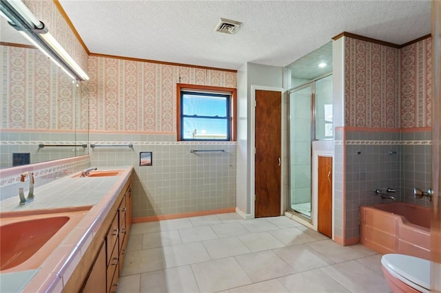 6461 Grand Caillou Rd, Houma, LA 70363 - full bathroom with vanity, independent shower and bath, a textured ceiling, and tile walls