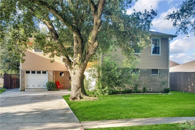 view of front of house featuring a garage and a front lawn