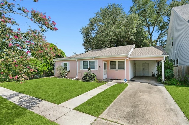 single story home with a front lawn and a carport