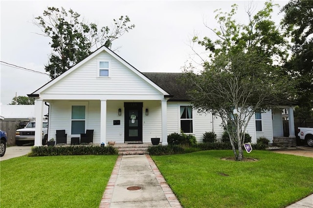 view of front of home with a porch and a front yard