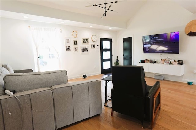 living room with hardwood / wood-style flooring and lofted ceiling