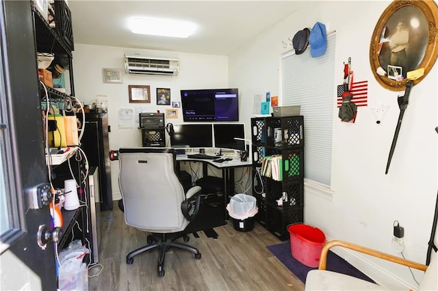 office featuring a wall mounted air conditioner and hardwood / wood-style floors