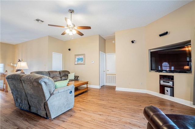 living room with light wood-type flooring and ceiling fan