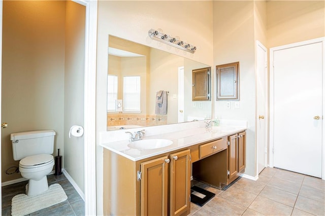 bathroom with tile patterned flooring, vanity, and toilet