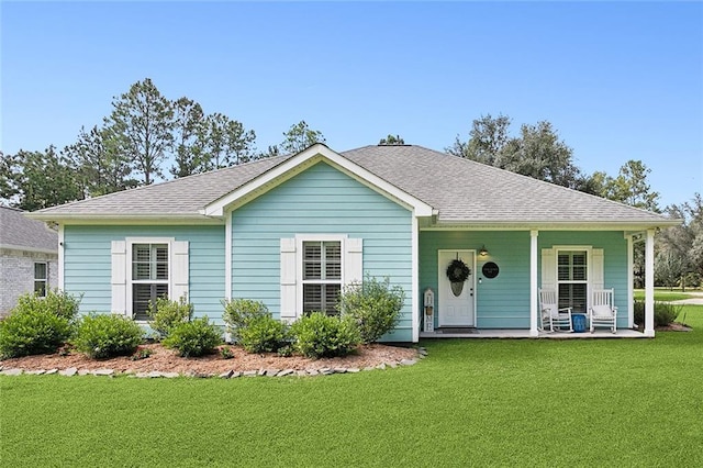 view of front of house with covered porch and a front lawn