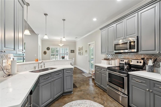 kitchen with appliances with stainless steel finishes, sink, hanging light fixtures, and gray cabinetry