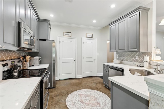 kitchen featuring sink, crown molding, appliances with stainless steel finishes, gray cabinets, and light stone countertops