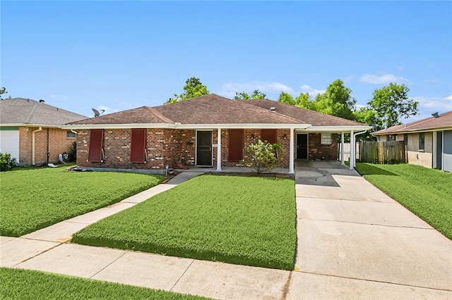 ranch-style home featuring a carport and a front lawn