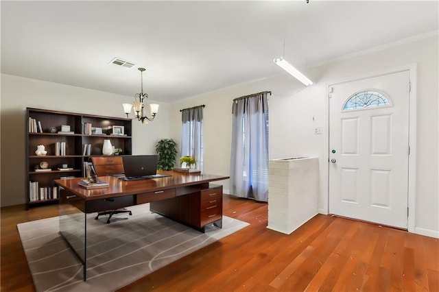 office space with hardwood / wood-style floors and a notable chandelier