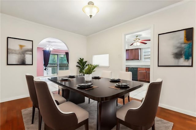 dining area featuring hardwood / wood-style flooring and crown molding