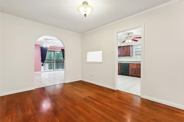 spare room featuring ornamental molding and light hardwood / wood-style flooring