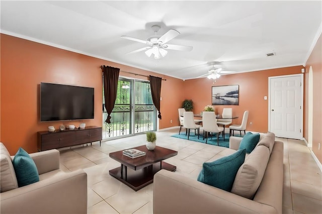 living room featuring ceiling fan, light tile patterned flooring, and ornamental molding