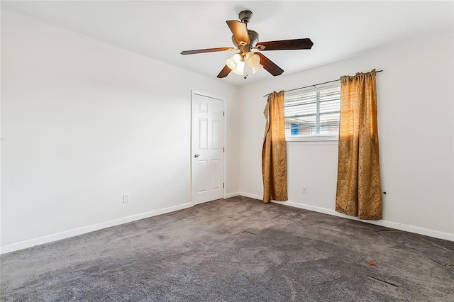 carpeted spare room featuring ceiling fan