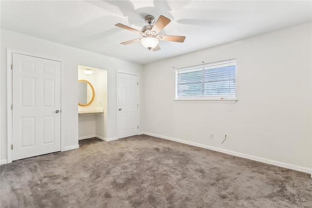 unfurnished bedroom with carpet, ceiling fan, and connected bathroom