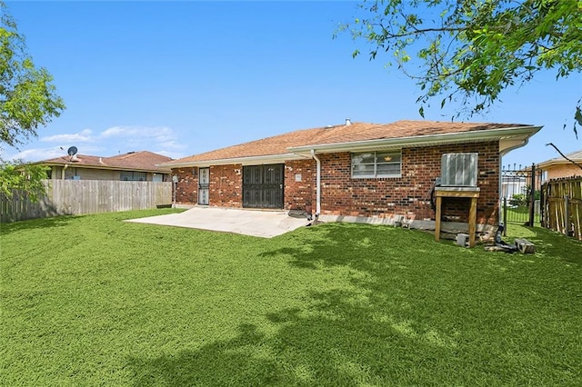 back of house with a patio area and a yard