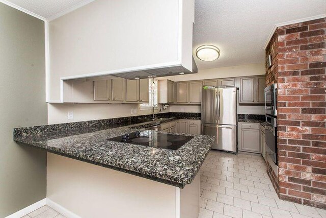 3412 Tolmas Dr, Metairie, LA 70002 - kitchen with stainless steel appliances, a peninsula, a sink, dark stone countertops, and crown molding