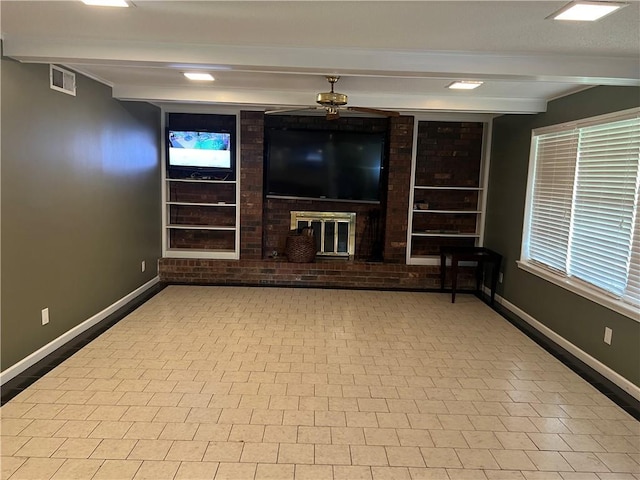 unfurnished living room featuring beamed ceiling and ceiling fan