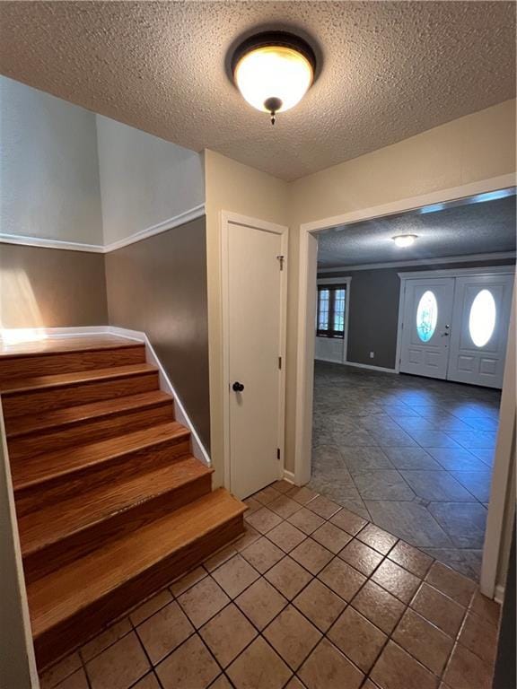 foyer with a textured ceiling