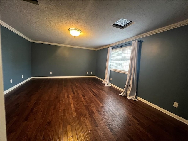 spare room featuring dark wood-type flooring, crown molding, and a textured ceiling