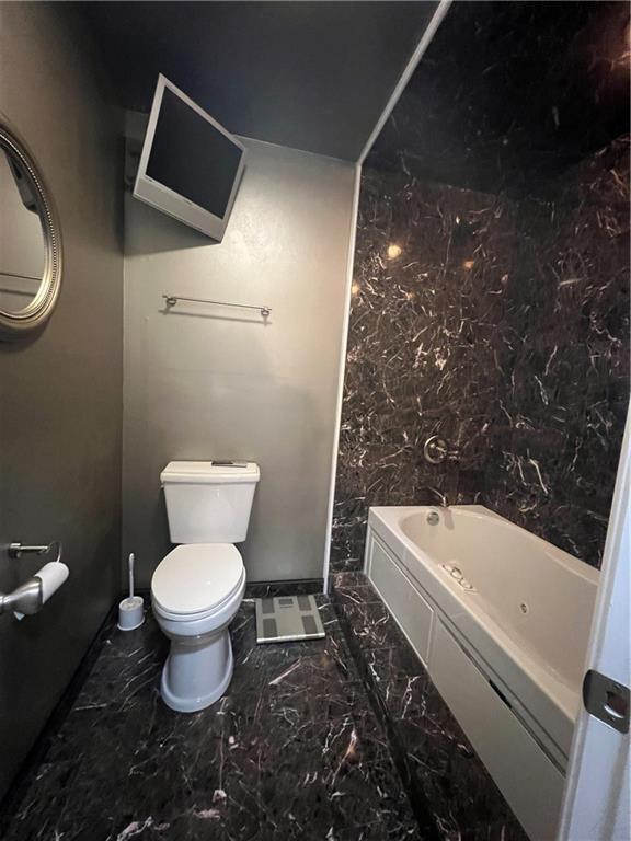 bathroom with shower / tub combination and toilet