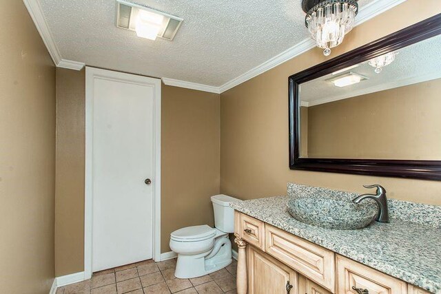 3412 Tolmas Dr, Metairie, LA 70002 - bathroom with a textured ceiling, vanity, toilet, tile patterned floors, and baseboards