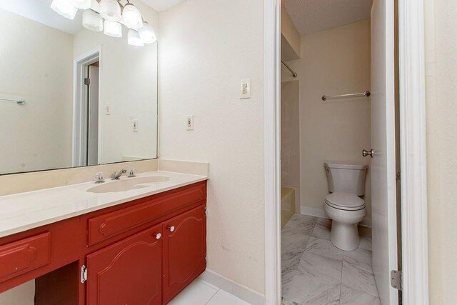 3412 Tolmas Dr, Metairie, LA 70002 - full bath with vanity, marble look tile flooring, toilet, washtub / shower combination, and baseboards