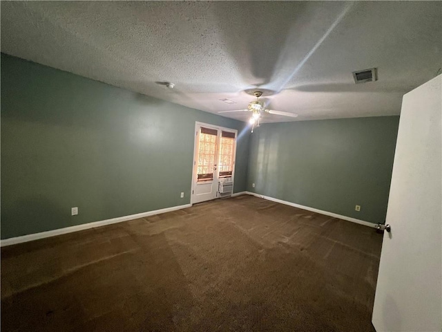 carpeted empty room featuring ceiling fan and a textured ceiling